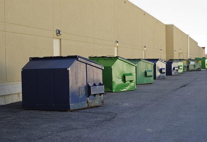 a construction worker moves construction materials near a dumpster in Glendale OH